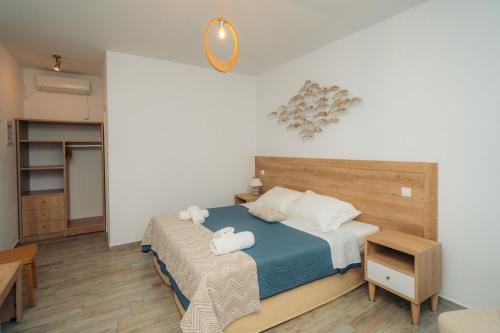 a bedroom with a bed with two towels on it at Arhontou in Apollonia