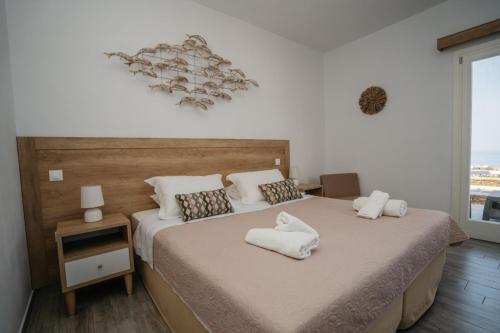 a bedroom with a bed with white towels on it at Arhontou in Apollonia