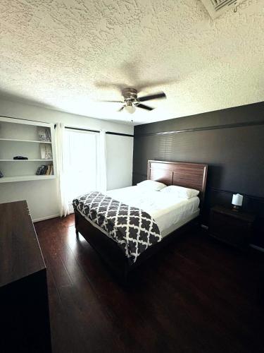 a bedroom with a bed and a ceiling fan at Super Cozy 4 Bedroom - Sleeps 10 Great for families and professionals in Katy