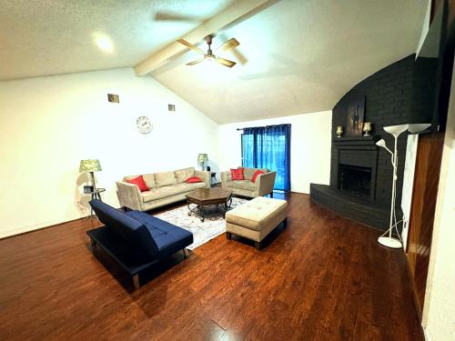 a living room with a couch and a fireplace at Super Cozy 4 Bedroom - Sleeps 10 Great for families and professionals in Katy