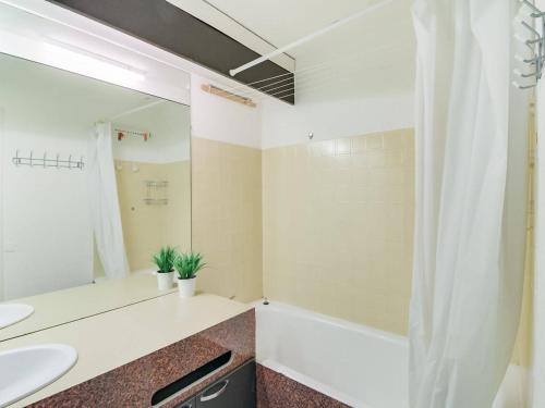 a bathroom with a sink and a tub and a mirror at Appartement La Mongie, 2 pièces, 5 personnes - FR-1-404-57 in La Mongie