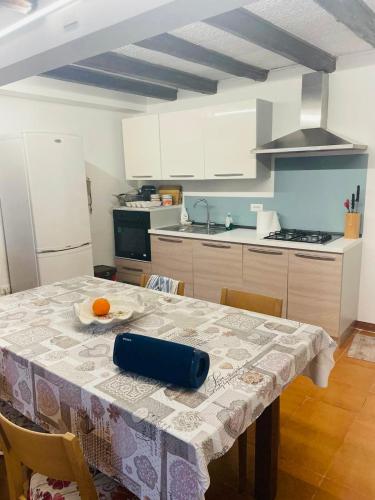 a kitchen with a table with an orange on it at Casa Borgo Pietro in Galzignano