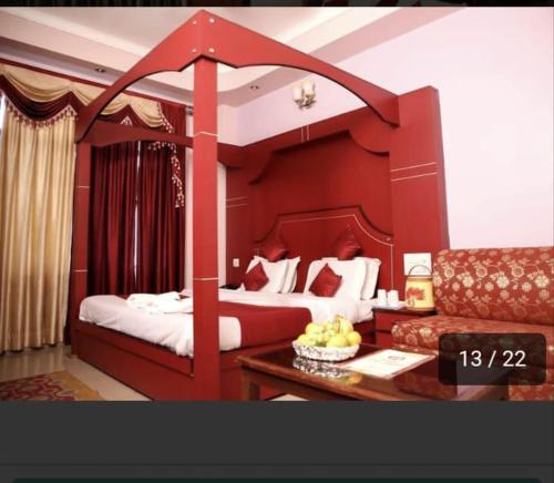 a hotel room with a large bed and a couch at Vipul Palace, katra in Katra