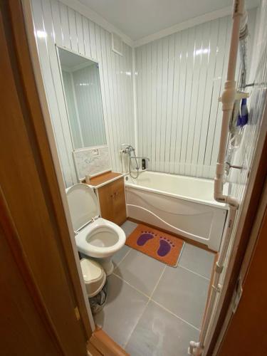 y baño con aseo, bañera y lavamanos. en 1-x Квартира в центре города по доступной цене, en Rudny
