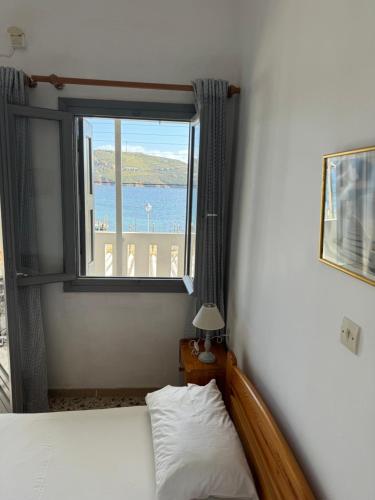 a bedroom with a bed and a window with a view at Akti Rooms And Studios in Livadion
