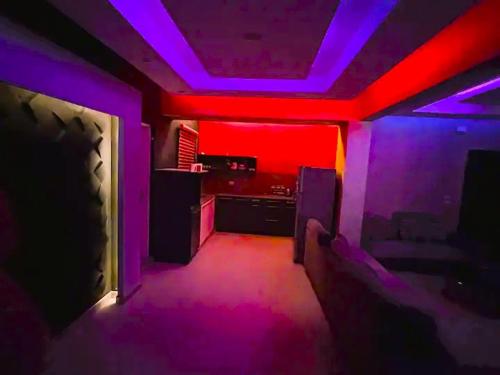 a room with purple and pink lights in a room at Rawdat Zayed Compound in Sheikh Zayed