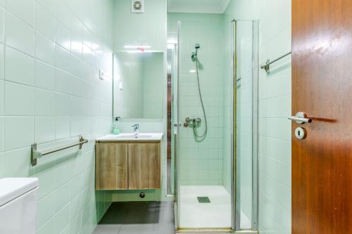 a bathroom with a shower and a sink and a toilet at Casa da Música Guesthouse in Porto