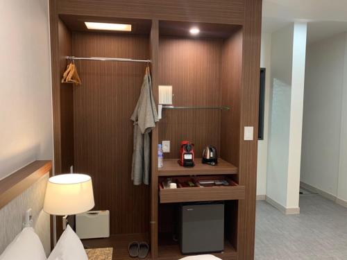 a hotel room with a desk in a room at Hotel J's in Gumi