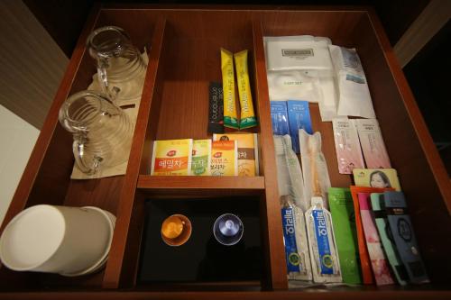 a book shelf with books and other items on it at Hotel J's in Gumi