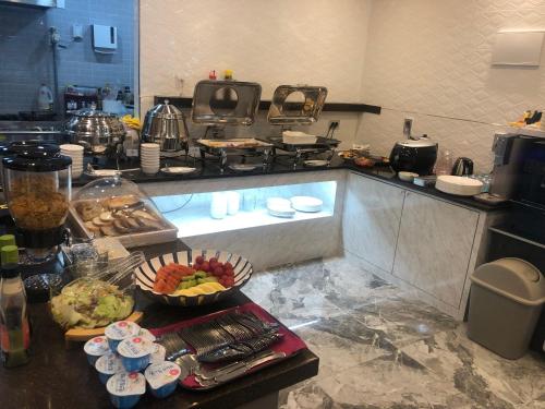 a kitchen with a counter with some food on it at Hotel J's in Gumi