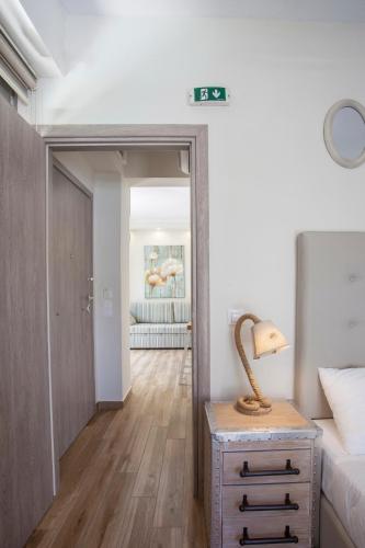 a bedroom with a bed and a lamp on a night stand at Kassiopea home by the sea 1 in Pefkochori