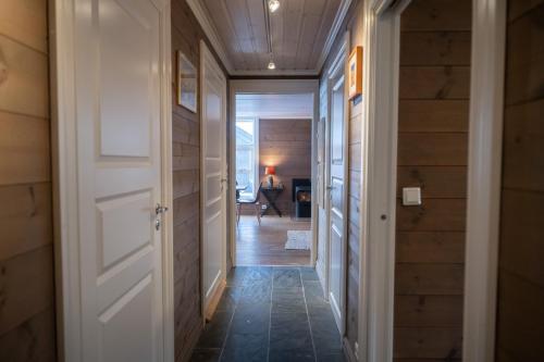 a hallway with a white door and a room at Stranda Fjellgrend - with jacuzzi & 3 bedrooms in Stranda