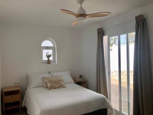 a bedroom with a bed and a ceiling fan at Modern private Suite at fantastic villa near Fuengirola in Mijas