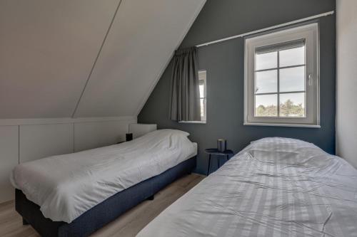 1 dormitorio con 2 camas y ventana en HUB Resorts Knuitershoek, 