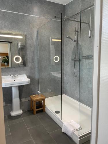 a bathroom with a shower and a sink at Elan Valley Hotel in Rhayader