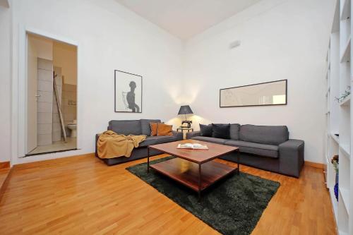 a living room with a couch and a table at Amleto Apartments in Rome