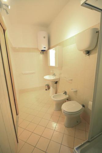 a bathroom with a toilet and a sink at Arcadia in Tropea