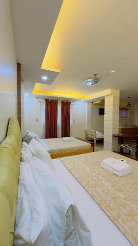 a hotel room with two beds in a room at La Anclar Hotel in Davao City