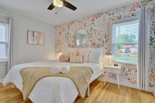 a bedroom with a bed with two towels on it at Sheridan Wildflower Downtown Family Fun w Firepit in Colorado Springs