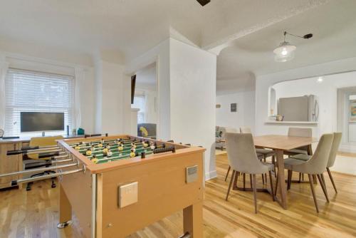 a living room with a table and a foos ball at Sheridan Wildflower Downtown Family Fun w Firepit in Colorado Springs