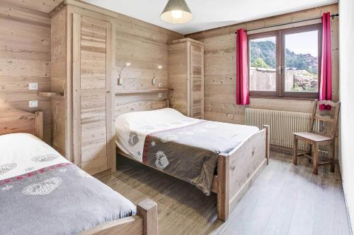a bedroom with two beds and a window at Les Congères in Le Grand-Bornand