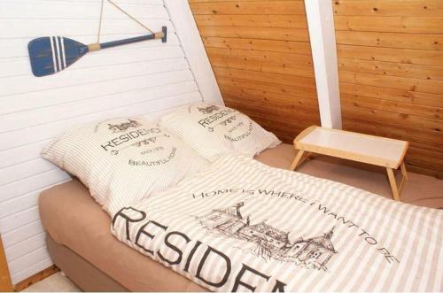a bed in a sauna with two pillows on it at Zum-Piraten in Damp