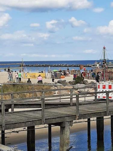 a pier at a beach with people on it at Zum-Piraten in Damp