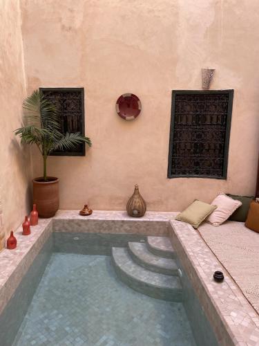 a room with a swimming pool in a room at Riad Paquerette in Marrakesh
