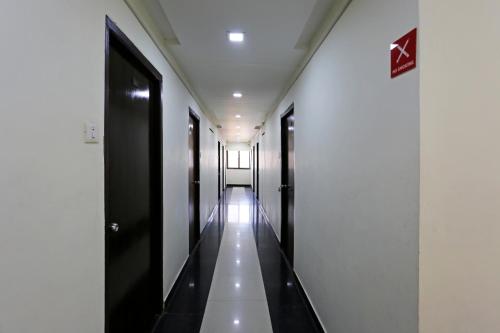 a hallway of a building with black doors at OYO Flagship Hotel Golden Wings in Udaipur