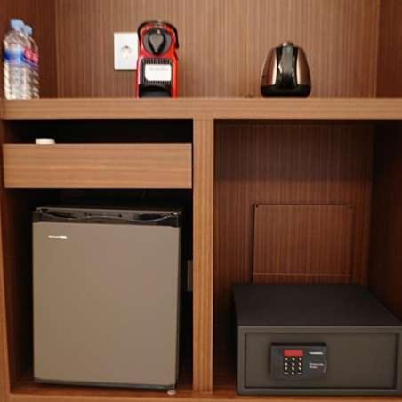 a wooden shelf with a microwave and a microwave at Hotel J's in Gumi
