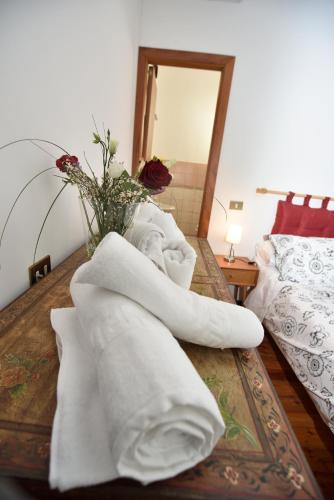 a pile of towels on a table in a bedroom at Casale del Passatore sas in Rocchette