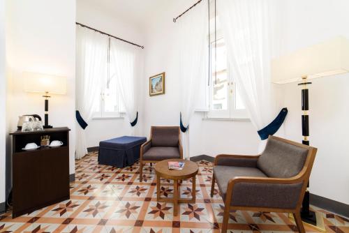 a living room with two chairs and a table at Amalfi Luxury House in Amalfi