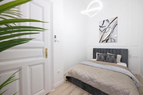 a bedroom with a bed and a plant at Exclusive & Prestigious Central Residence w/ Balcony in Budapest