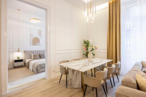 a dining room with a table and a couch at Exclusive & Prestigious Central Residence w/ Balcony in Budapest