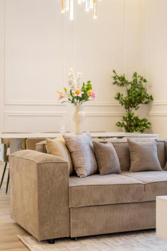 a couch with pillows on it in a living room at Exclusive & Prestigious Central Residence w/ Balcony in Budapest