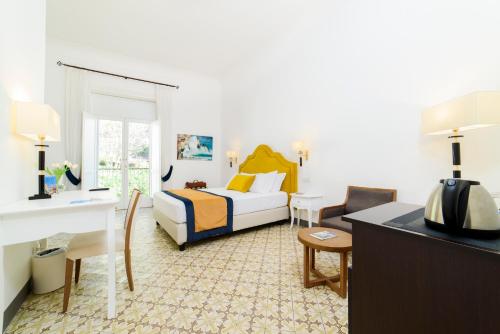 a hotel room with a bed and a desk at Amalfi Luxury House in Amalfi