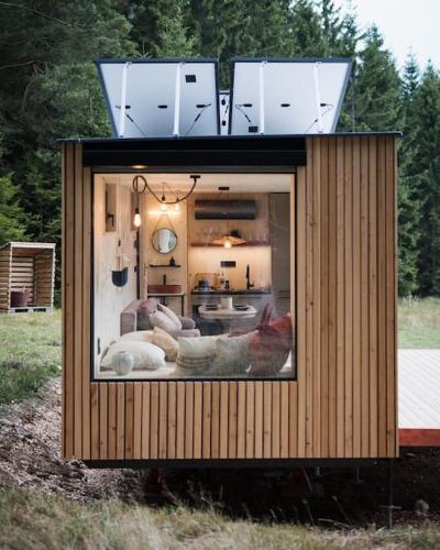 a small house with a window in a field at Tiny House Manka in Malšín