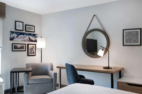 a room with a desk and a chair and a mirror at Hampton Inn Anderson/Alliance Business Park in Anderson