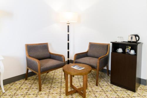 two chairs and a table in a room at Amalfi Luxury House in Amalfi