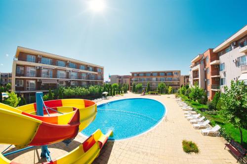 a swimming pool with a slide in a resort at Holiday Garden Resort in Sunny Beach