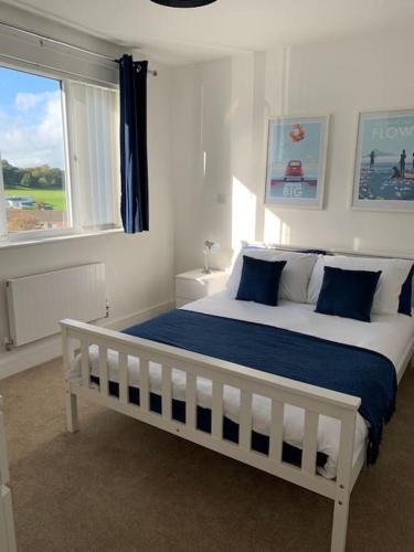 a white bed in a bedroom with a window at Entire 3bed house close to westward ho/ town in Bideford