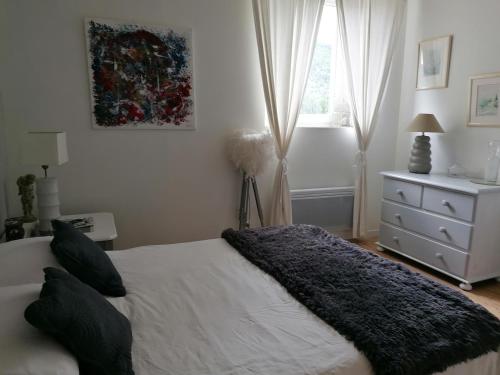 a bedroom with a bed and a dresser and a window at MARIAC , Chambres d'hôtes "AU TILLEUL" 6km du Cheylard in Mariac