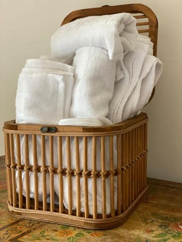 a basket filled with towels on a floor at Casale del Passatore sas in Rocchette