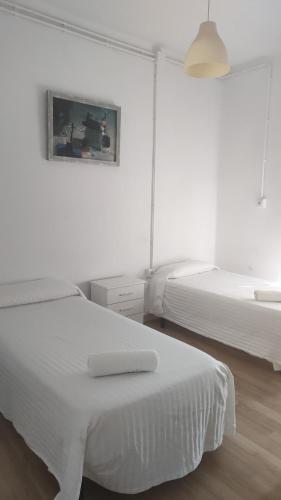 Ένα ή περισσότερα κρεβάτια σε δωμάτιο στο Arce apartamentos