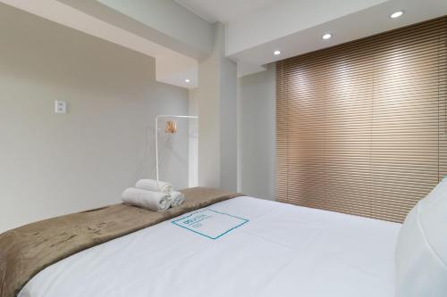 Llit o llits en una habitació de Residencial Oliveiras - Apartamento 2
