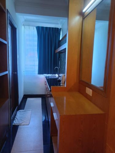 a bathroom with a sink and a mirror at Fratini's Hotel Labuan in Labuan