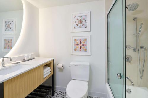 a bathroom with a toilet and a sink and a shower at OUTRIGGER Waikiki Paradise Hotel in Honolulu