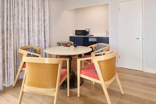 a dining room with a table and chairs at OUTRIGGER Waikiki Paradise Hotel in Honolulu