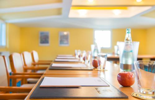 a long wooden table with bottles and an apple on it at Bellevue Rheinhotel in Boppard
