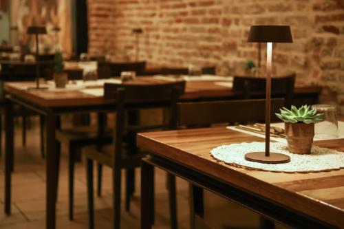 a table with a potted plant on top of it at Locanda Ponte Dante in Treviso